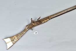 AN ANTIQUE ARAB FLINTLOCK MUZZLE LOADING MUSKET, with decorative bone and mother of pearl inlays