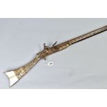 AN ANTIQUE ARAB FLINTLOCK MUZZLE LOADING MUSKET, with decorative bone and mother of pearl inlays