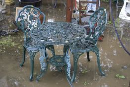 A GREEN CAST ALUMINIUM CIRCULAR GARDEN TABLE, diameter 65cm a pair of matching chairs (sd) and a set