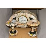 AN EARLY 20TH CENTURY VEINED MARBLE CLOCK GARNITURE, the domed clock with enamel dial, lozenge