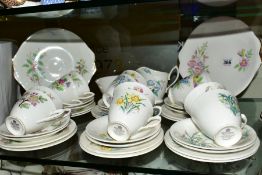 ROYAL ALBERT 'FLOWER OF THE MONTH' TEAWARES comprising of twelve tea cups and saucers, twelve tea