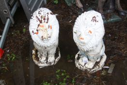 AN OPPOSING PAIR OF COMPOSITE GARDEN LION FIGURES on shaped bases, height 52cm