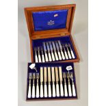 AN OAK CASED EDWARDIAN SET OF SILVER AND MOTHER OF PEARL HANDLED DESSERT KNIVES AND FORKS, makers