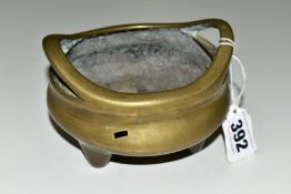 A CHINESE POLISHED BRONZE TRIPOD CENSER, 18th / 19th Century, looped handles, cast mark to