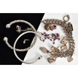 A SELECTION OF ITEMS, to include a charm bracelet with nine charms such as a hinged open church,