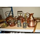 TWO LARGE COPPER KETTLES, one having a brass finial to the cover, with a smaller copper kettle,