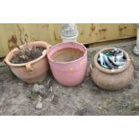 THREE GARDEN PLANTERS including a terracotta with four handles, height 30cm, a glazed pink, height