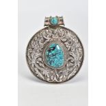 A NAVAJO PENDANT, white metal of circular design set with a central turquoise piece, with embossed