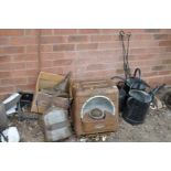 THREE OVER PAINTED VINTAGE WATERING CANS, a vintage heater, three hooked wrought iron bars and two