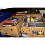 FOUR BOXES OF SUNDRY ITEMS, including books, framed pictures, VHS, DVD's, five demi Johns, a