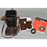 A ROLLEIFLEX OLD STANDARD TLR CAMERA with Tessar 3.5 75mm lenses, tatty leather case, and four