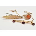 TWO EARLY 20TH CENTURY BROOCHES AND FOB, the first a bar brooch set with three round garnets and