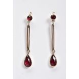 A PAIR OF GARNET DROP EARRINGS, each designed with a round cut garnet suspending an open work bar