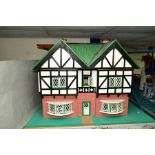 A MODERN WOODEN DOLLS HOUSE, modelled as a double fronted Tudorbethan Villa, front opening to reveal