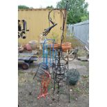 A QUANTITY OF WROUGHT IRON PLANTERS including a globe sundial, a three tiered planter, various