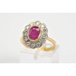 AN 18CT GOLD CLUSTER RING, set with a central oval ruby with a round brilliant cut diamond surround,