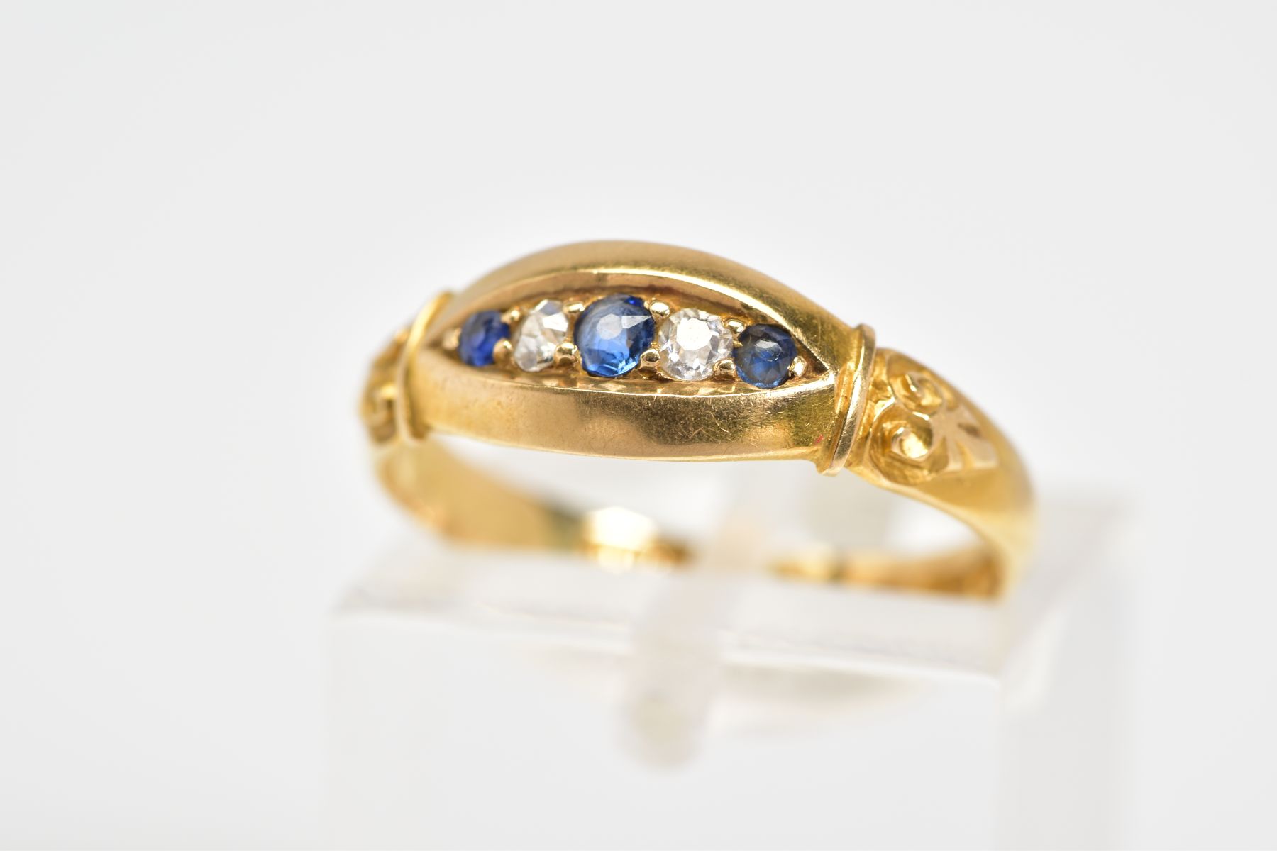 AN EARLY 20TH CENTURY FIVE STONE RING, set with three circular cut sapphires interspaced by two