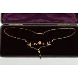 A GOLD EDWARDIAN SPLIT PEARL NECKLACE, formed of swallows and floral detail between blade bar