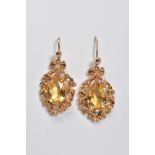 A PAIR OF DROP EARRINGS, each designed with a pear cut citrine within a filigree surround, to the