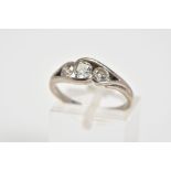 AN 18CT WHITE GOLD DIAMOND RING, set with three round brilliant cut diamonds in an open work cross
