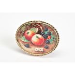 A BROOCH, of oval design featuring a fruit painting within a collet mount and rope twist surround,
