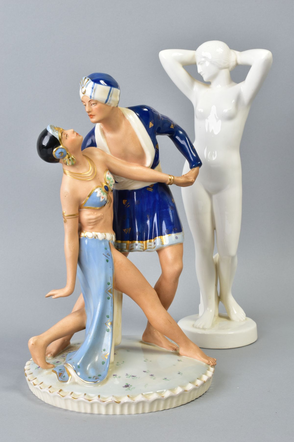 A ROYAL DUX FIGURE GROUP OF TWO EXOTIC DANCERS, on a circular base, the underside with painted '