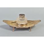 AN EDWARDIAN SILVER INKSTAND OF NAVETTE FORM, fitted to the centre with an oval facet cut glass