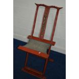 AN ORIENTAL RED GROUND FOLDING CHAIR, cow horn top rail, carved splat back with gilt finish