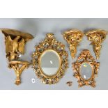 A COLLECTION OF SIX GILTWOOD ITEMS, comprising two small oval mirrors within ornate foliate