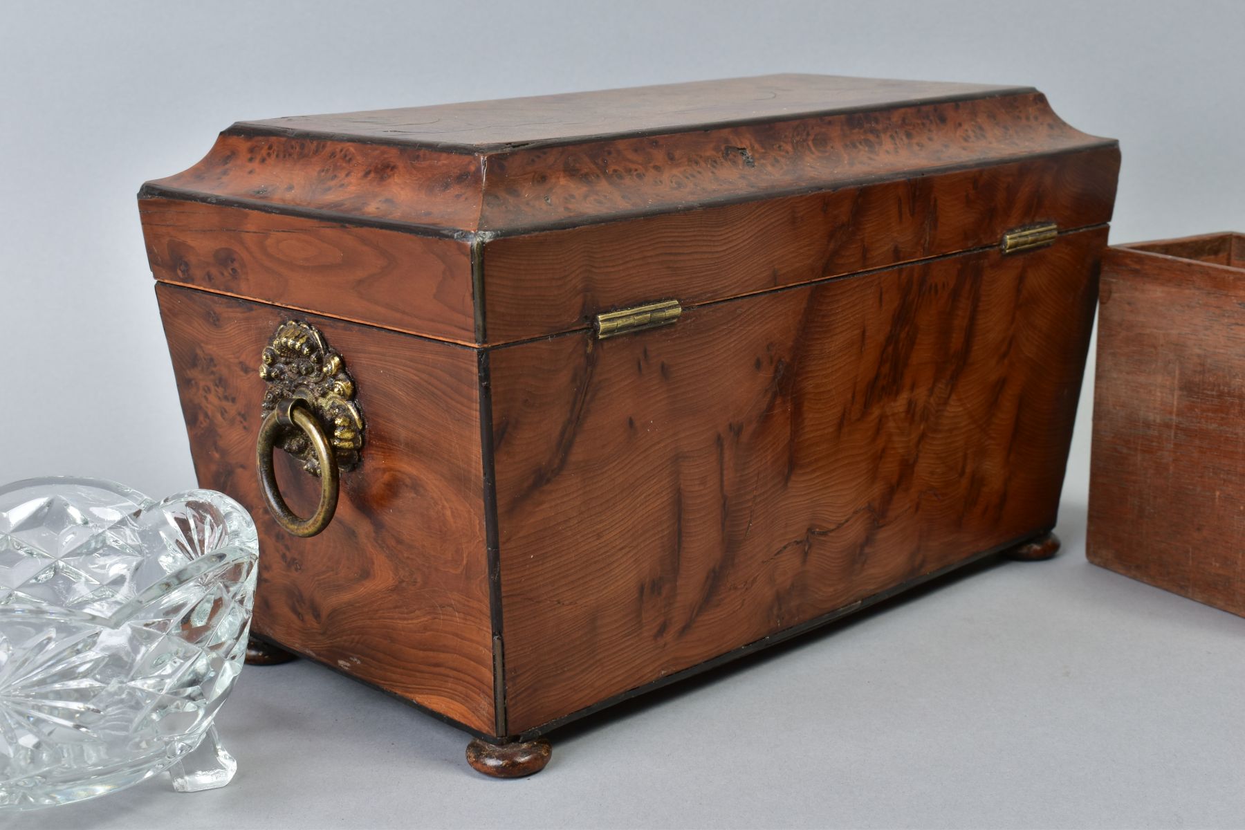 AN EARLY VICTORIAN AMBOYNA TEA CADDY, of sarcophagus form, gilt metal ring handles to sides, bun - Image 6 of 6