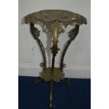 A BRASS TRIPLE TIER TORCHERE STAND, with foliate pierced decoration on triple scrolled legs united