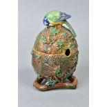 A VICTORIAN MAJOLICA PRESERVE JAR AND COVER, of ovoid form, modelled with a Bluetit perched on a