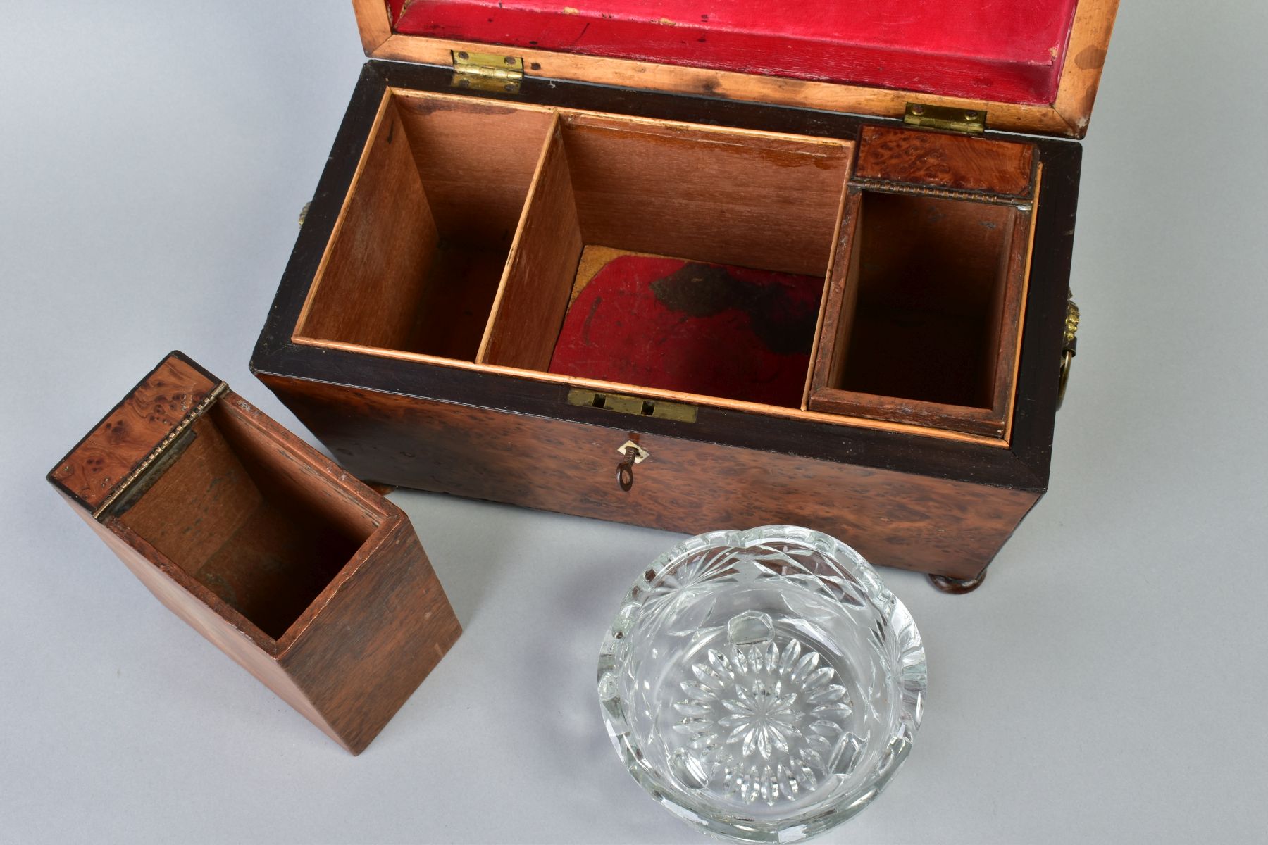 AN EARLY VICTORIAN AMBOYNA TEA CADDY, of sarcophagus form, gilt metal ring handles to sides, bun - Image 2 of 6