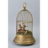 AN EARLY 20TH CENTURY CLOCKWORK AUTOMATON OF A CAGE OF THREE BIRDS, stamped brass base, on three