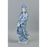 AN ORIENTAL PORCELAIN FIGURE OF A FEMALE IN FLOWING ROBES, probably Guanyin, with fish basket,