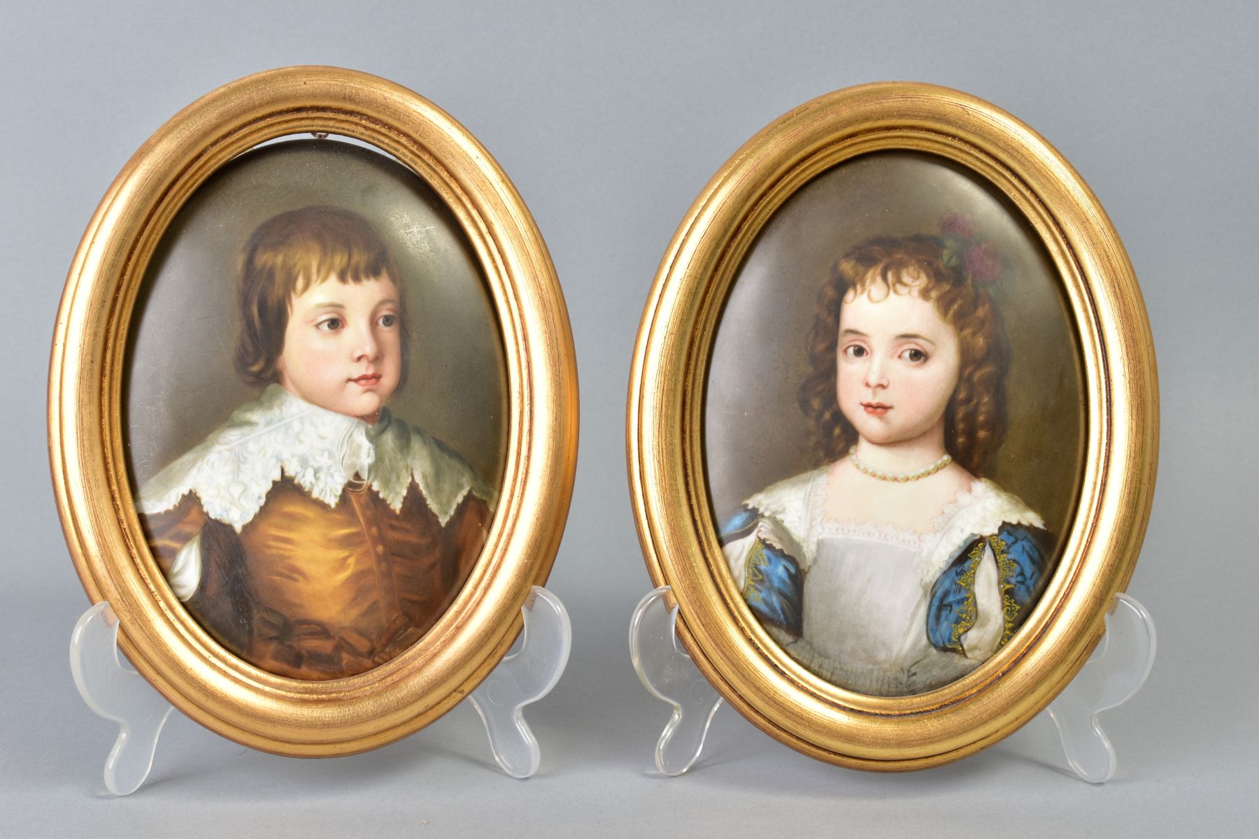 A PAIR OF 19TH CENTURY KPM PORCELAIN OVAL PLAQUES, painted with portraits of a 17th Century boy