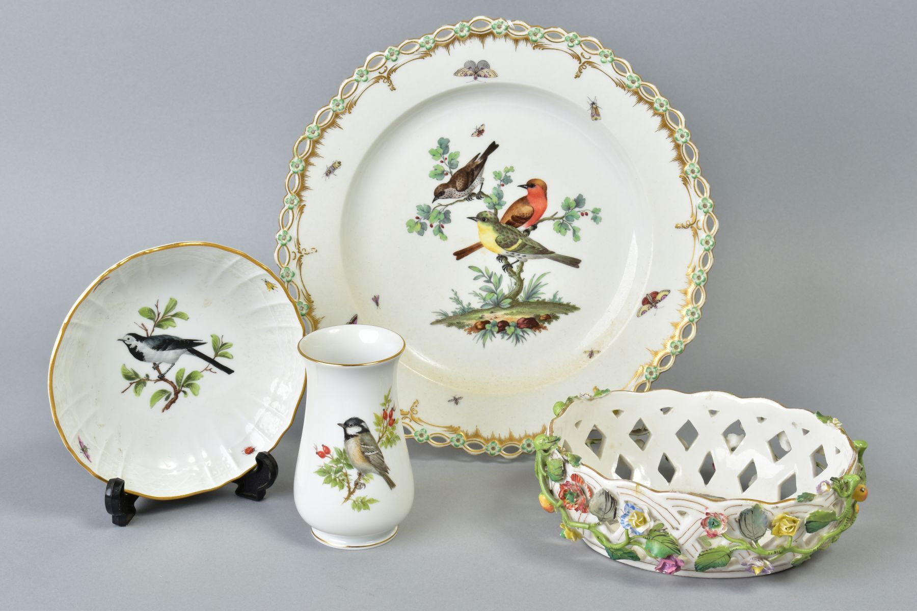 A 19TH CENTURY BERLIN PORCELAIN PLATE WITH RETICULATED RIM, painted with three birds, perched in a