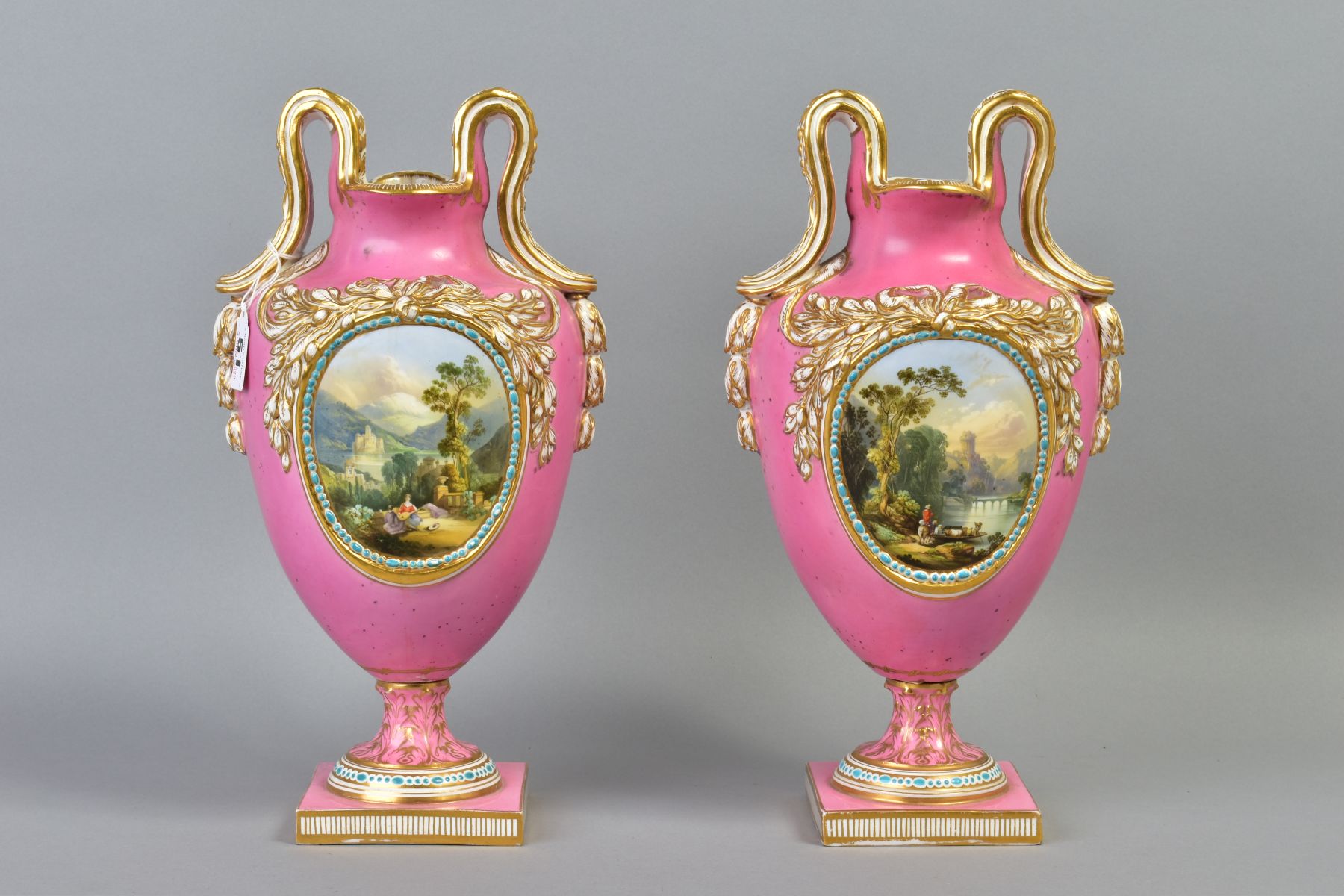 A PAIR OF VICTORIAN PORCELAIN TWIN HANDLED BALUSTER VASES, oval necks with foliate moulded