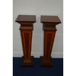 A PAIR OF REPRODUCTION EDWARDIAN STYLE MAHOGANY AND BANDED PLANT STANDS, of a square tapering