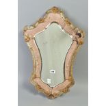 A LATE 19TH/EARLY 20TH CENTURY VENETIAN WALL MIRROR OF CARTOUCHE SHAPE, gilt and clear glass