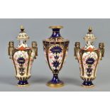 A PAIR OF ROYAL CROWN DERBY IMARI 1128 PATTERN VASES AND COVERS, domed covers, angular handles,