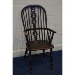 AN EARLY 20TH CENTURY STAINED OAK SPINDLE BACK WINDSOR ARMCHAIR, on a crinoline stretcher