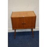 A 1970'S TEAK TWO DOOR RECORD CABINET, on cylindrical tapering legs, width 61cm x depth 37cm x