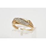 A 9CT GOLD DIAMOND RING, designed as a rectangle panel set with a diagonal row of single cut