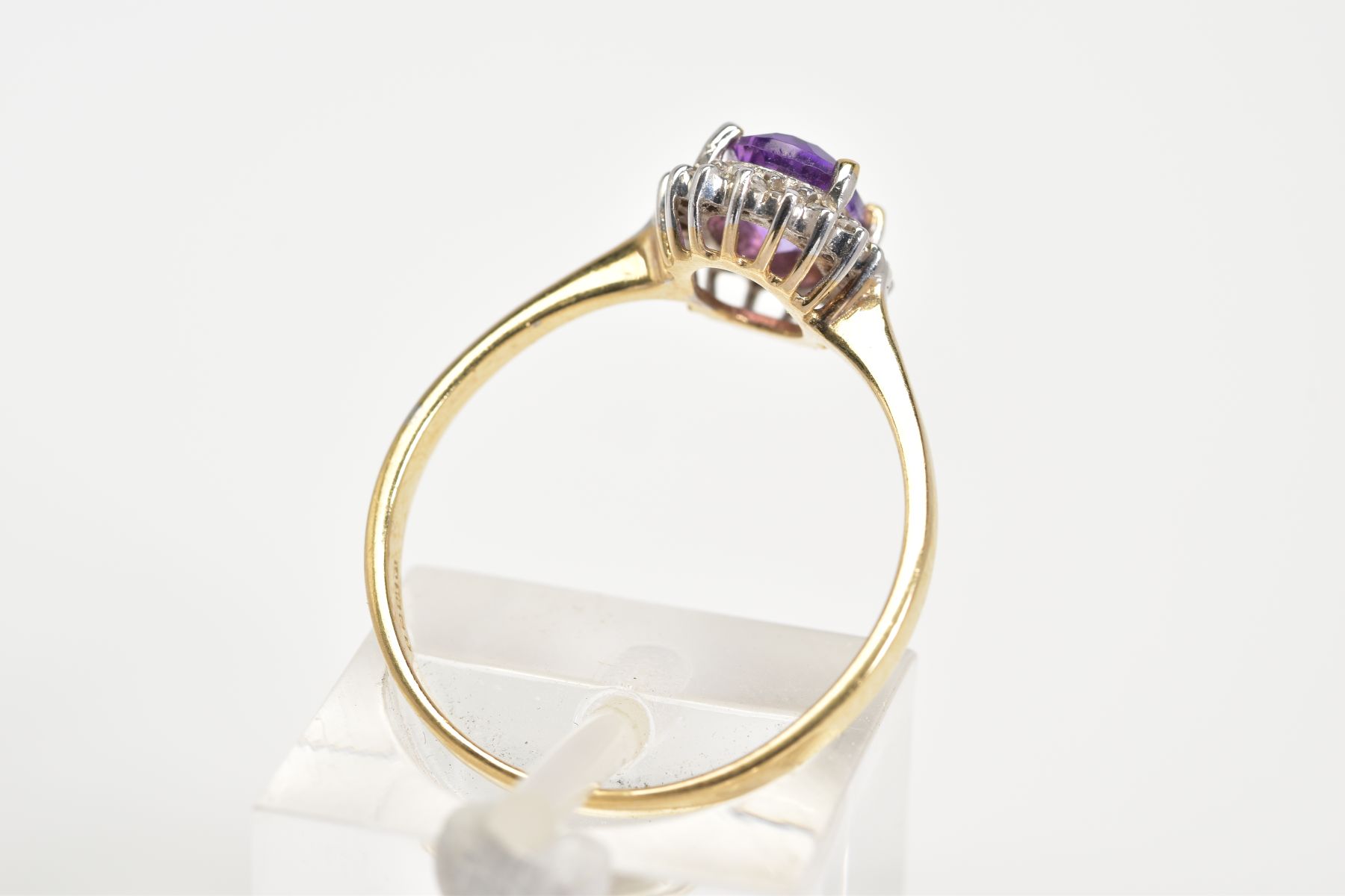 A 9CT GOLD CLUSTER RING, designed with a central oval cut amethyst and single cut diamond - Image 3 of 3