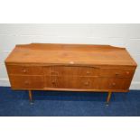 A MID 20TH CENTURY TEAK SIDEBOARD, with six assorted drawers, on four cylindrical tapering legs,