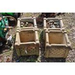 A SET OF FOUR COMPOSITE GARDEN PLANTERS, with geometric lattice work detail to all facets, 32cm