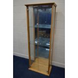 A MODERN BEECH TWO DOOR DISPLAY CABINET, with three glass shelves, with a single light, width 70cm x