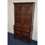 AN OLD CHARM OAK LEAD GLAZED TWO DOOR DISPLAY CABINET, two internal glass shelves, above two drawers