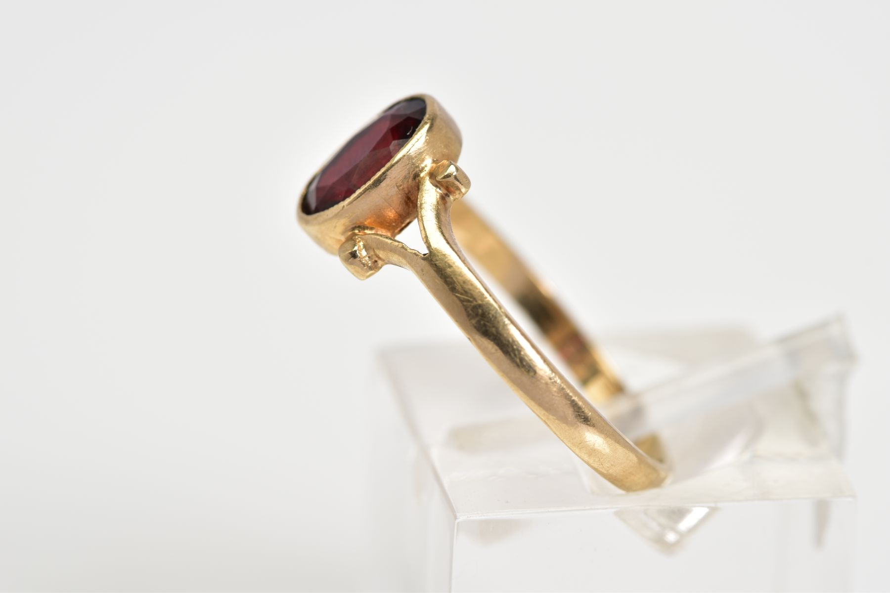 A 9CT GOLD GARNET RING, set with a central oval cut garnet to the bifurcated shoulders and plain - Image 2 of 3